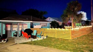 A house with a patio area featuring outdoor furniture and a barbecue grill.