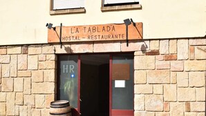 A building with a sign reading "L'A TABLADA HOSTAL - RESTAURANTE" and a door labeled "HR". - Hostal La Tablada (Navaleno)