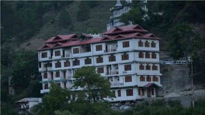 A multi-story building with a traditional architectural style, featuring a central courtyard and multiple balconies.