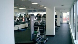 A gym with exercise equipment, a treadmill, and a weight bench. - Lincoln Rd & Collins Ave,  ROMANTIC 2 PERSON JACUZZI    (Miami Beach)
