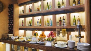 A bar area with shelves of various liquor bottles, a coffee machine, and a buffet with fruits and pastries. - Hotel Roadhouse, Thamel, Kathmandu- Contemporary Boutique (Kathmandu)