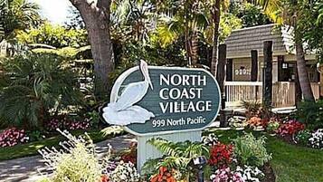 A sign for North Coast Village, indicating it is located at 999 North Pacific.