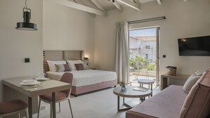 A modern bedroom with a bed, bedside table, and a TV mounted on the wall. - Notos Luxury Studios (Kefalonia)