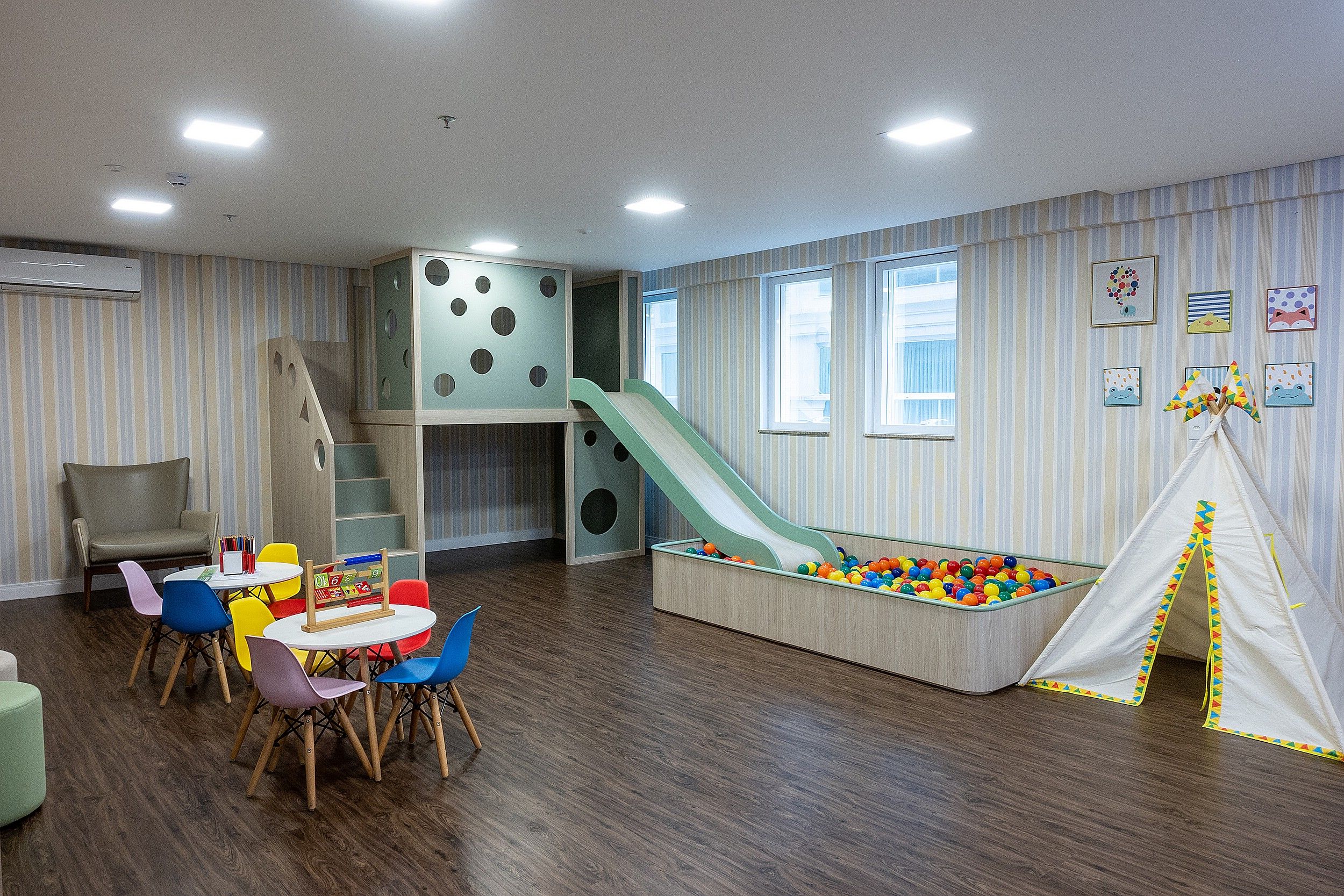 A children's play area with a slide, ball pit, and climbing structure.
