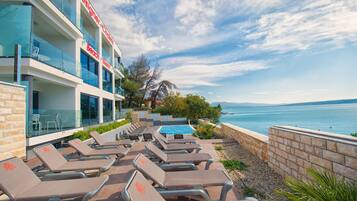 Outdoor pool, open 9 AM to 8 PM, pool umbrellas, sun loungers