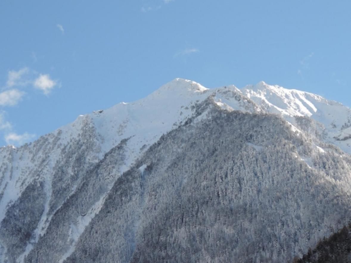 Une montagne enneigée sous un ciel dégagé.