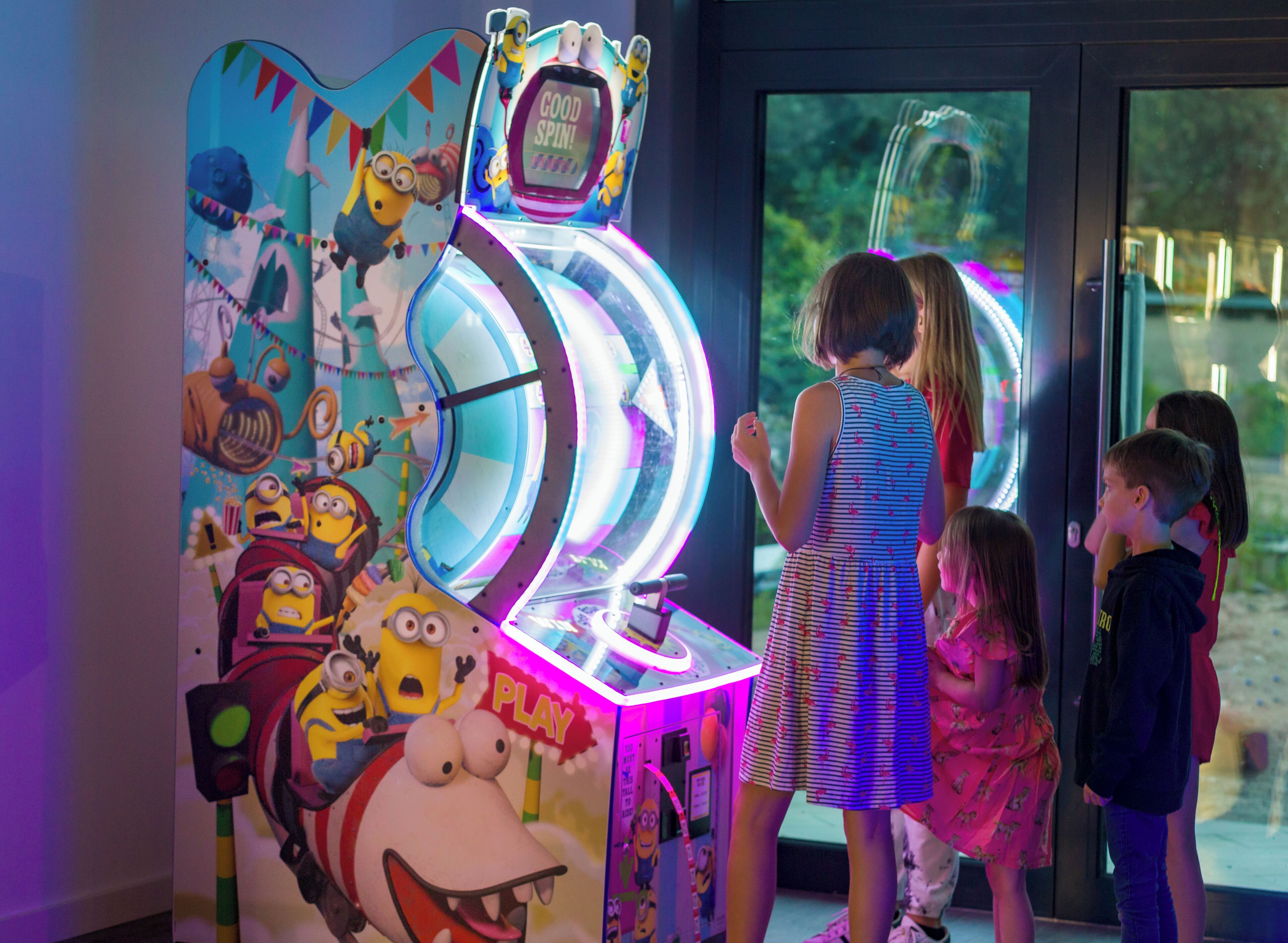 Ein Kinderspielbereich mit einem Spielautomaten im Minion-Design.