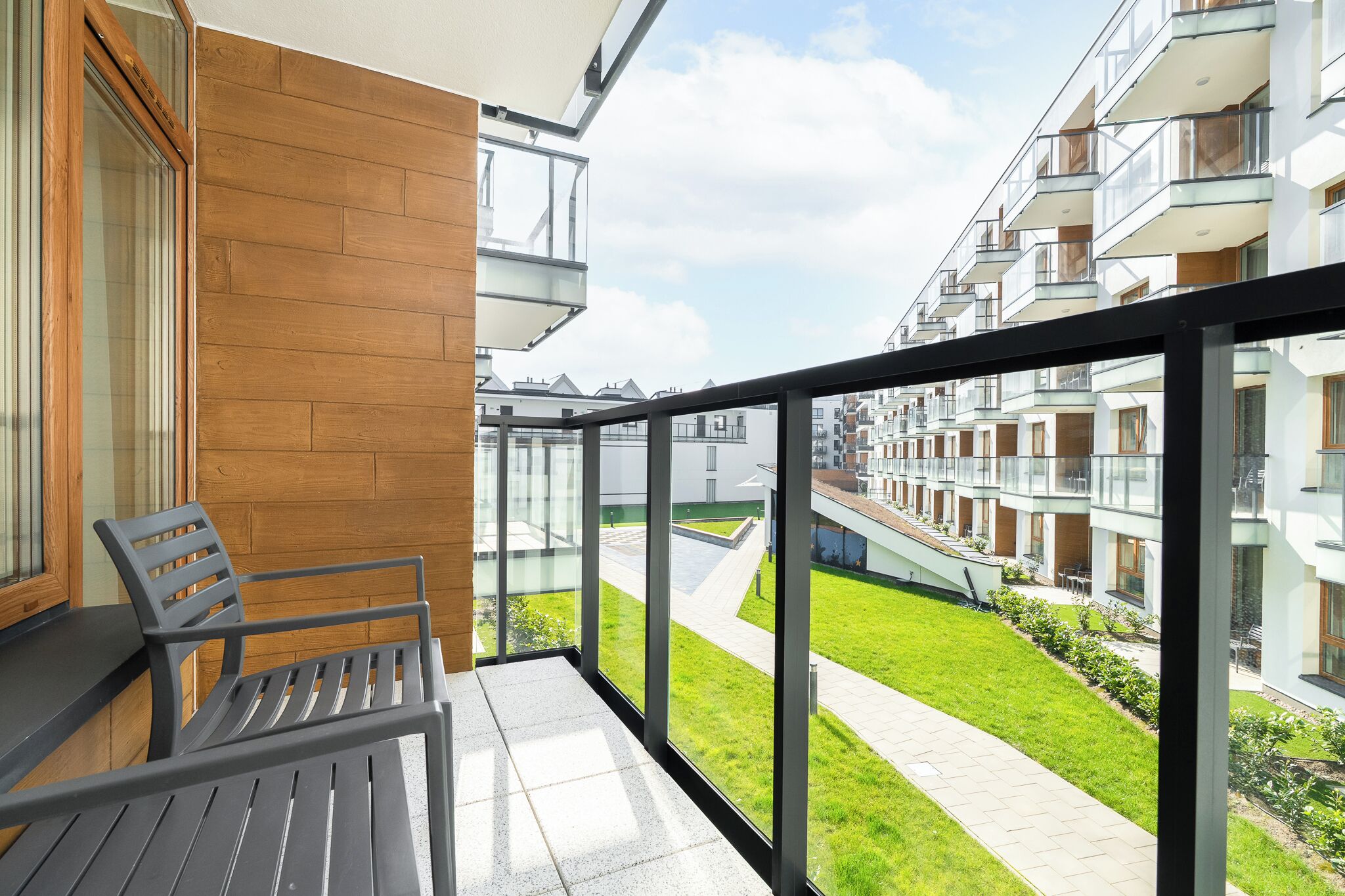 A balcony with a view of a residential building complex.
