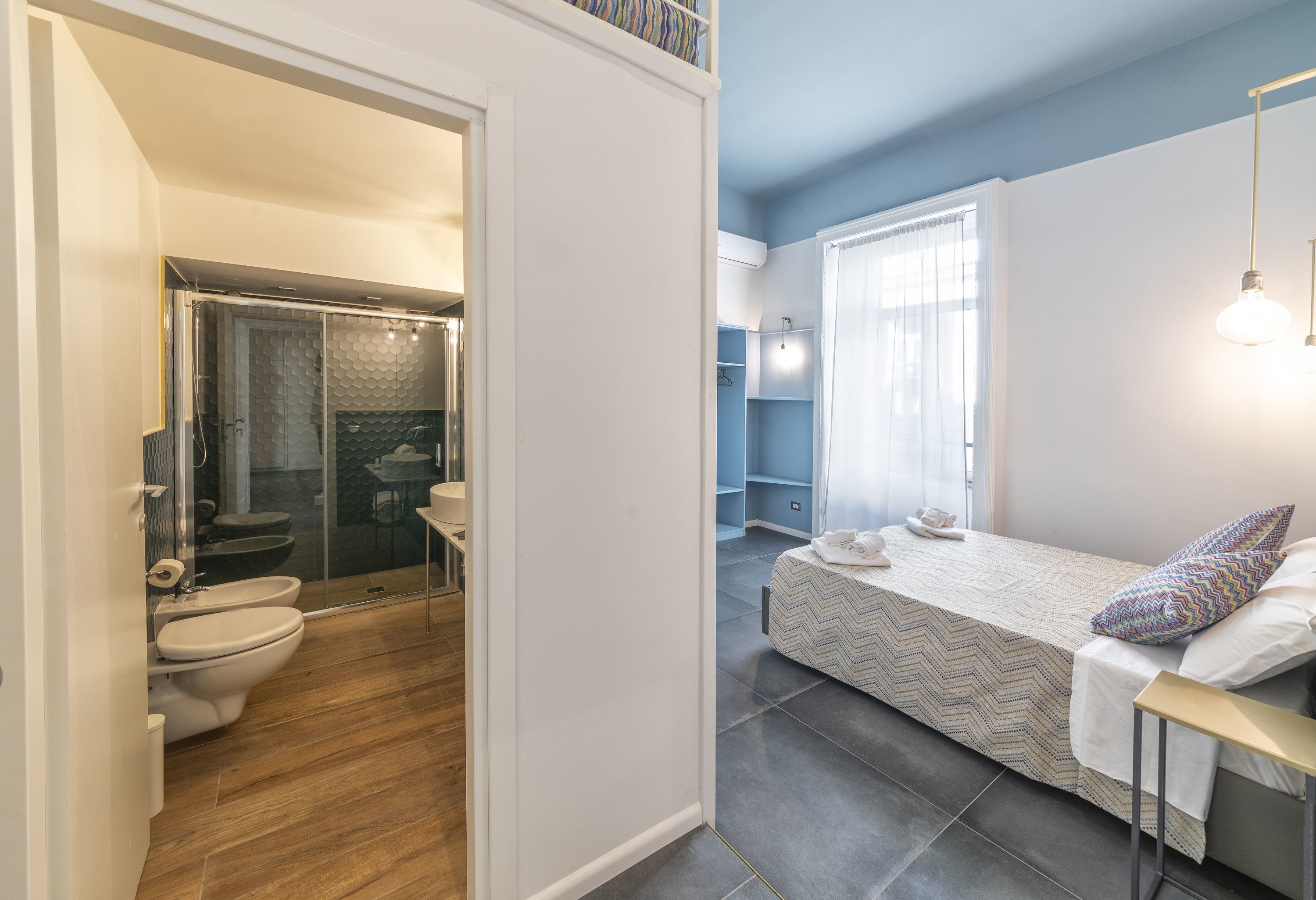 A modern bathroom with a shower, toilet, and sink.