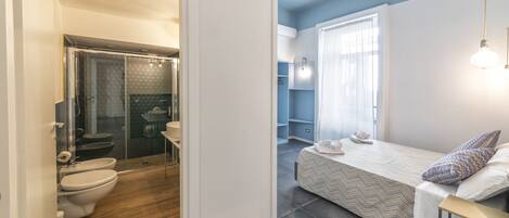 A modern bathroom with a shower, toilet, and sink.