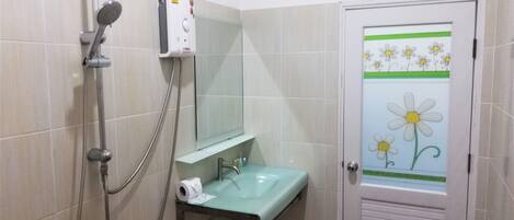 A bathroom with a shower, sink, and mirror.