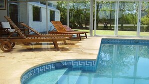 A pool area with lounge chairs and a clear view of the surrounding landscape.