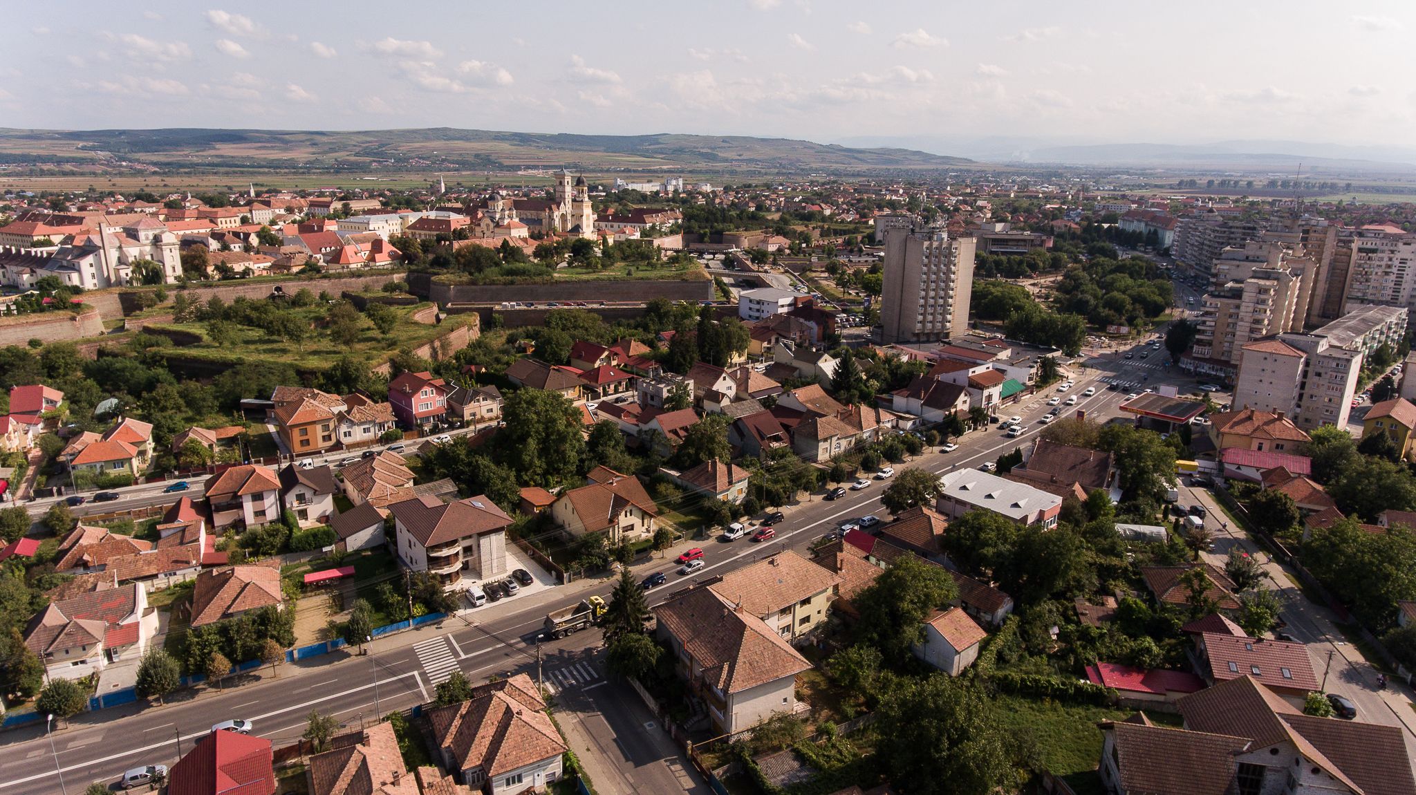 A town with historic architecture, including a prominent church tower and a large fortress-like building.