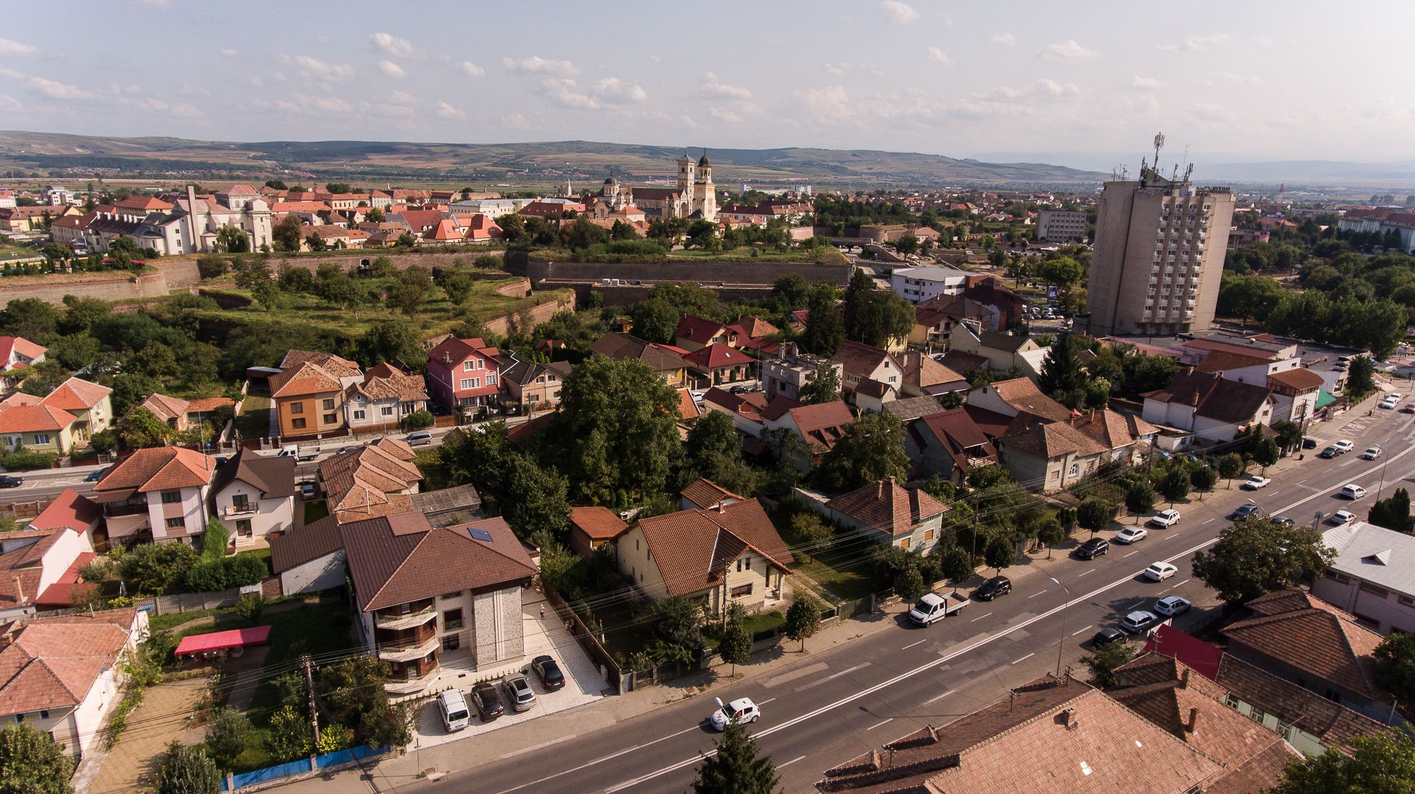 A town with a prominent church, a large tower, and a mix of residential and commercial buildings.