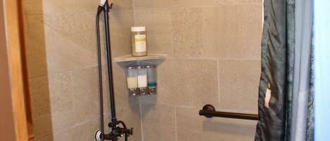 A bathroom with a bathtub, shower, and toilet.