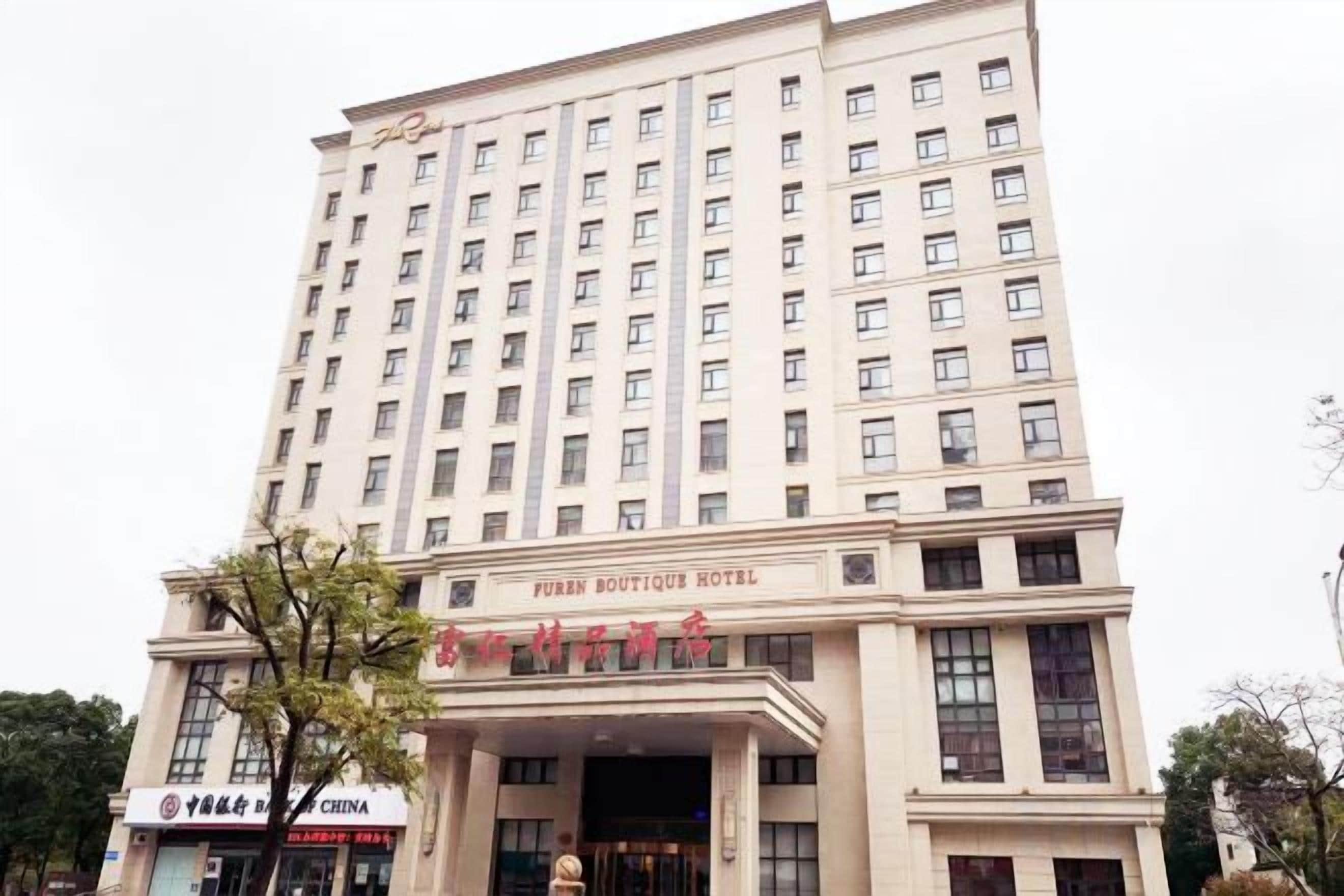 A multi-story hotel with a prominent entrance and signage for the Puren Boutique Hotel.