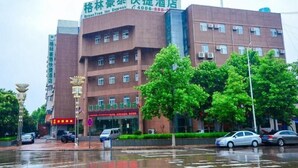 A hotel with a prominent sign for 'GreenTree Inn Express' and a contact number. - Greentree Inn (Xuzhou)