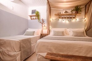 Een gezellige kamer met twee bedden, een houten bankje en sfeerverlichting.