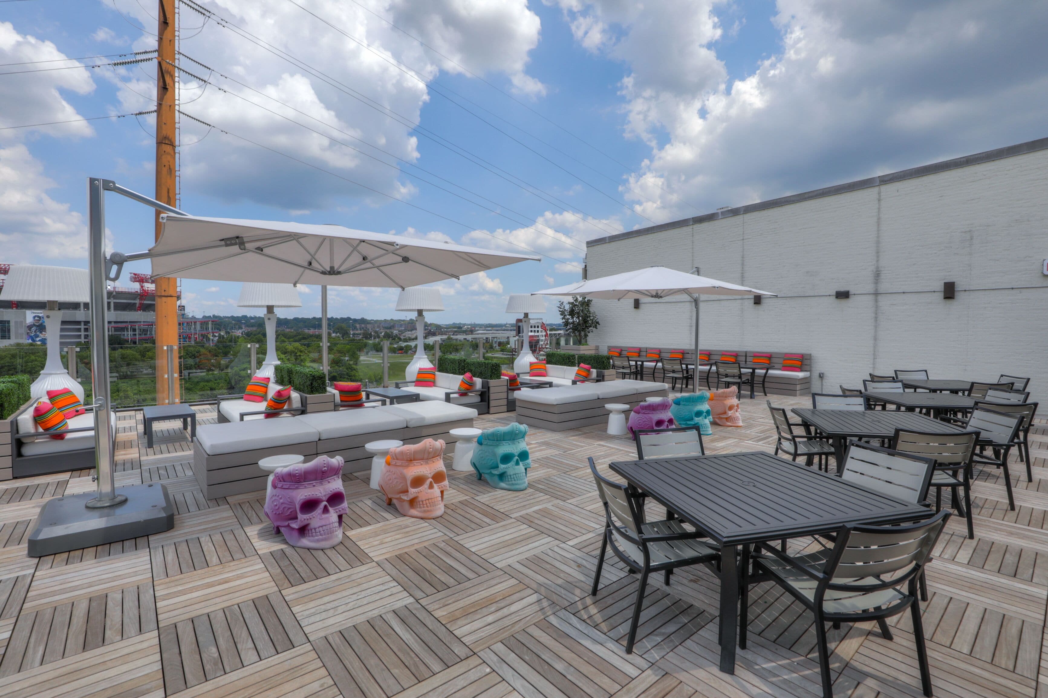 An outdoor patio with seating areas, umbrellas, and tables.