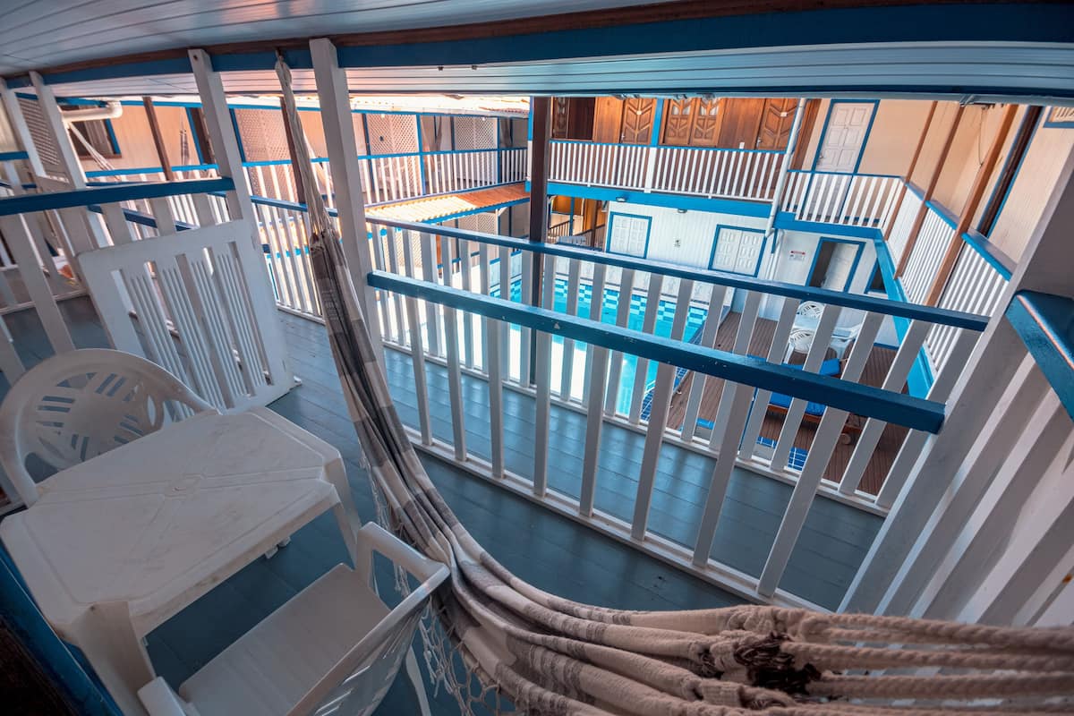 A pool area with white railings and a view of the pool.