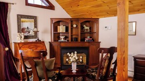 A traditional room with a fireplace, wooden furniture, and a mirror on the wall. - Stonecroft Inn (Ledyard)