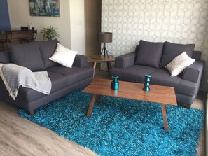 Relax in this stylish living room with a sofa, coffee table, and potted plant.
