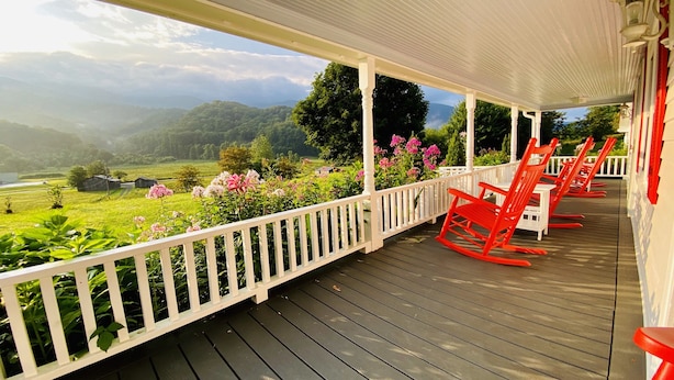A covered porch with a view of a green landscape and mountains. - 42 acres with Dramatic Mtn. Views...Close to Appalachian Trail (Bakersville)