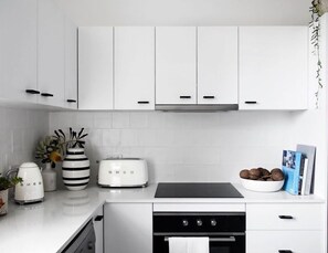 Enjoy cooking in this well-equipped kitchen with a toaster, kettle, and ample counter space.