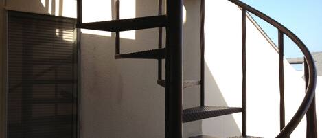 A spiral staircase with metal railings in a building.