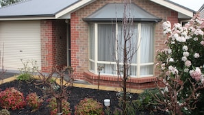 A residential house with a garage, a front porch, and a small garden with various plants. - C and C Tanunda (Tanunda)