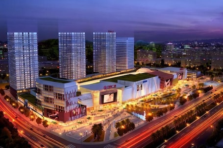 A modern building complex with multiple high-rise structures, a central plaza, and surrounding roads.. Guangzhou Yuxuan Hotel Apartment