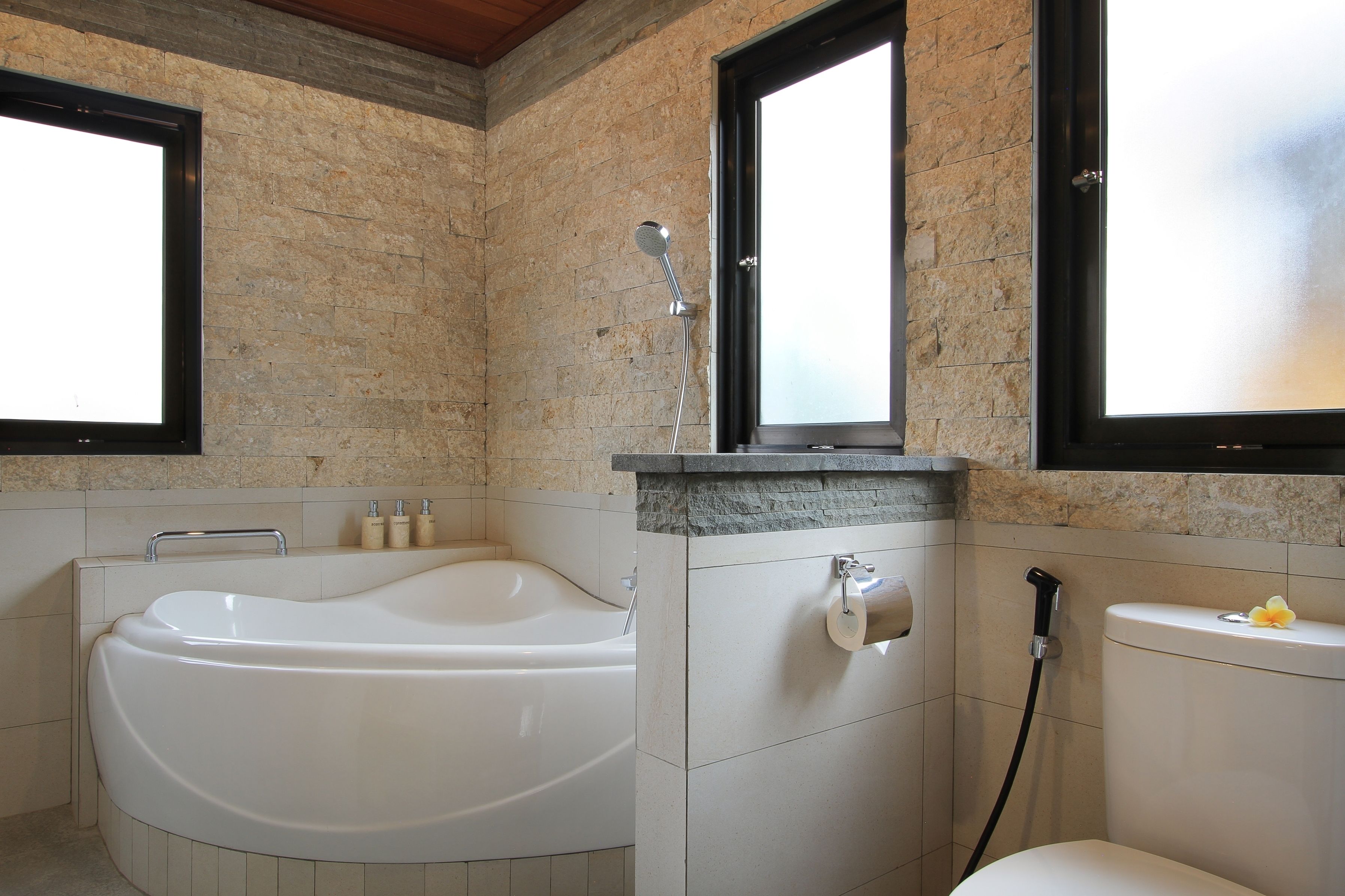 A bathroom with a bathtub, toilet, and shower.