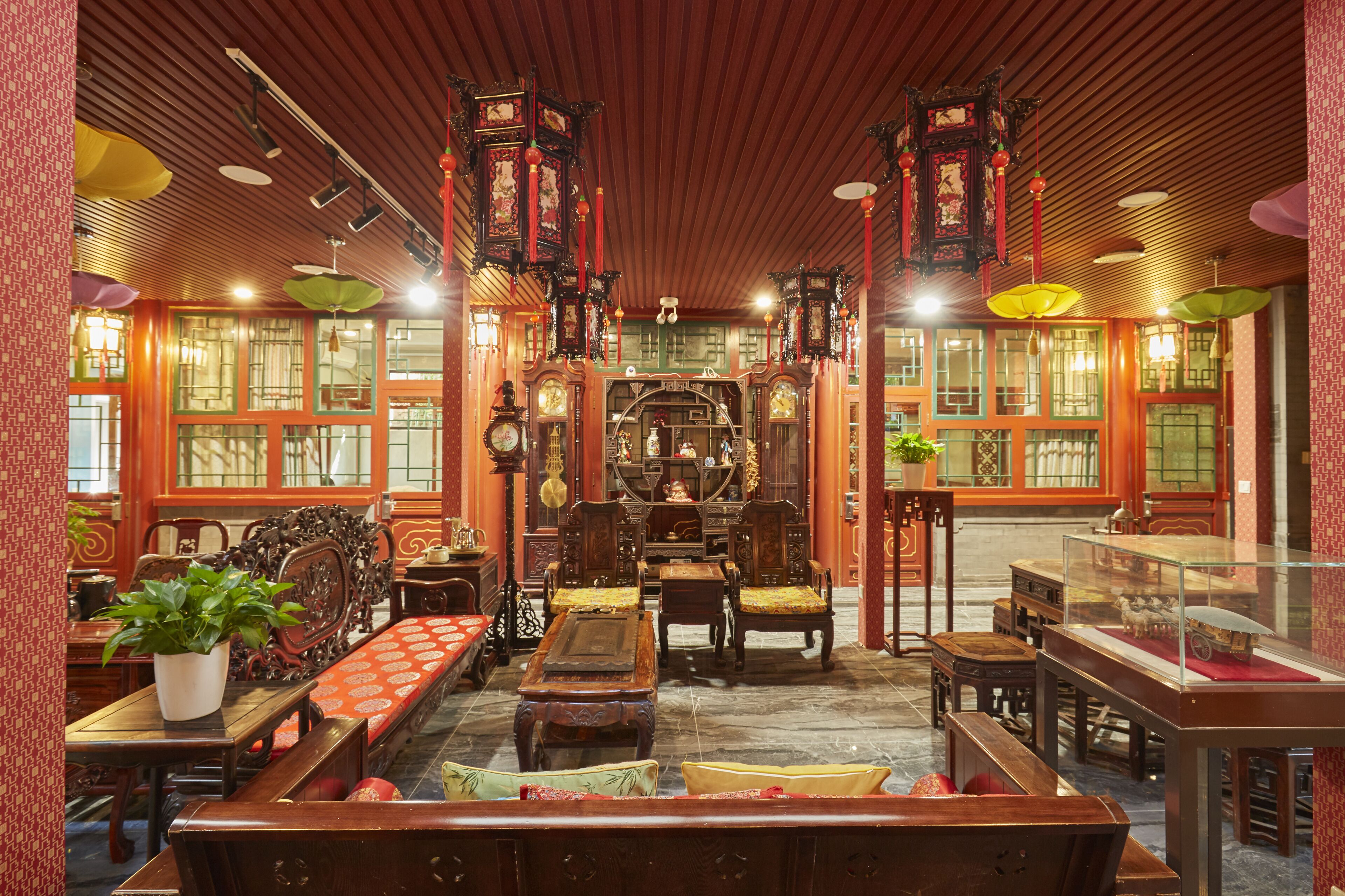 A traditional interior with wooden furniture, ornate decorations, and a central display case.