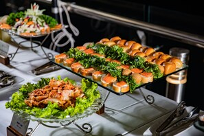 A buffet table with various food items including salads, sandwiches, and appetizers. - Stellar of the Seas (Hanoi)