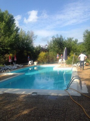 Seasonal outdoor pool, pool umbrellas, pool loungers