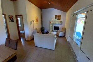 A spacious living area with a sofa, a TV, and a fireplace.