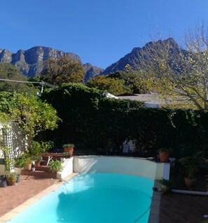 A swimming pool with a mountain backdrop.