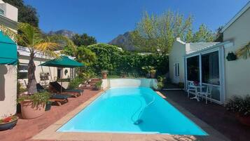 Seasonal outdoor pool, pool umbrellas, pool loungers