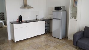 A compact kitchen with a microwave, refrigerator, and a sink. - QUINTERO SUITES (NOPAL AND VEROL) 2 COUPLES? BOOK THE TWO SUITES (San Bartolomé)