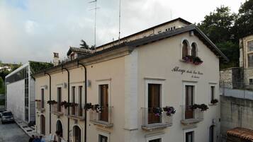 A building with multiple balconies, each with flower boxes.