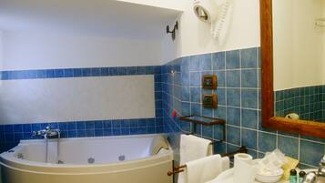 A bathroom with a bathtub, a sink, and a toilet.
