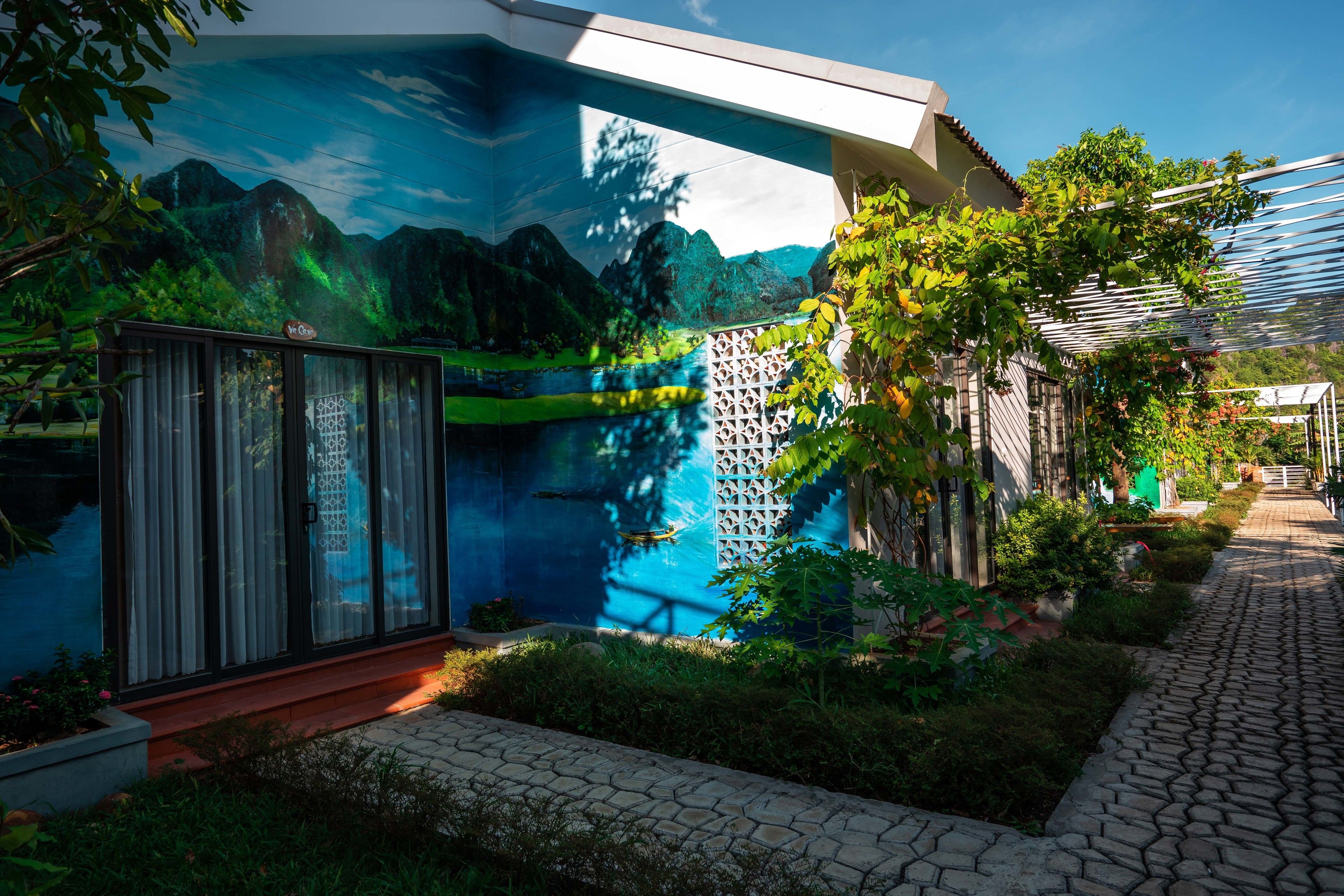 A modern building with a mural of a mountainous landscape.