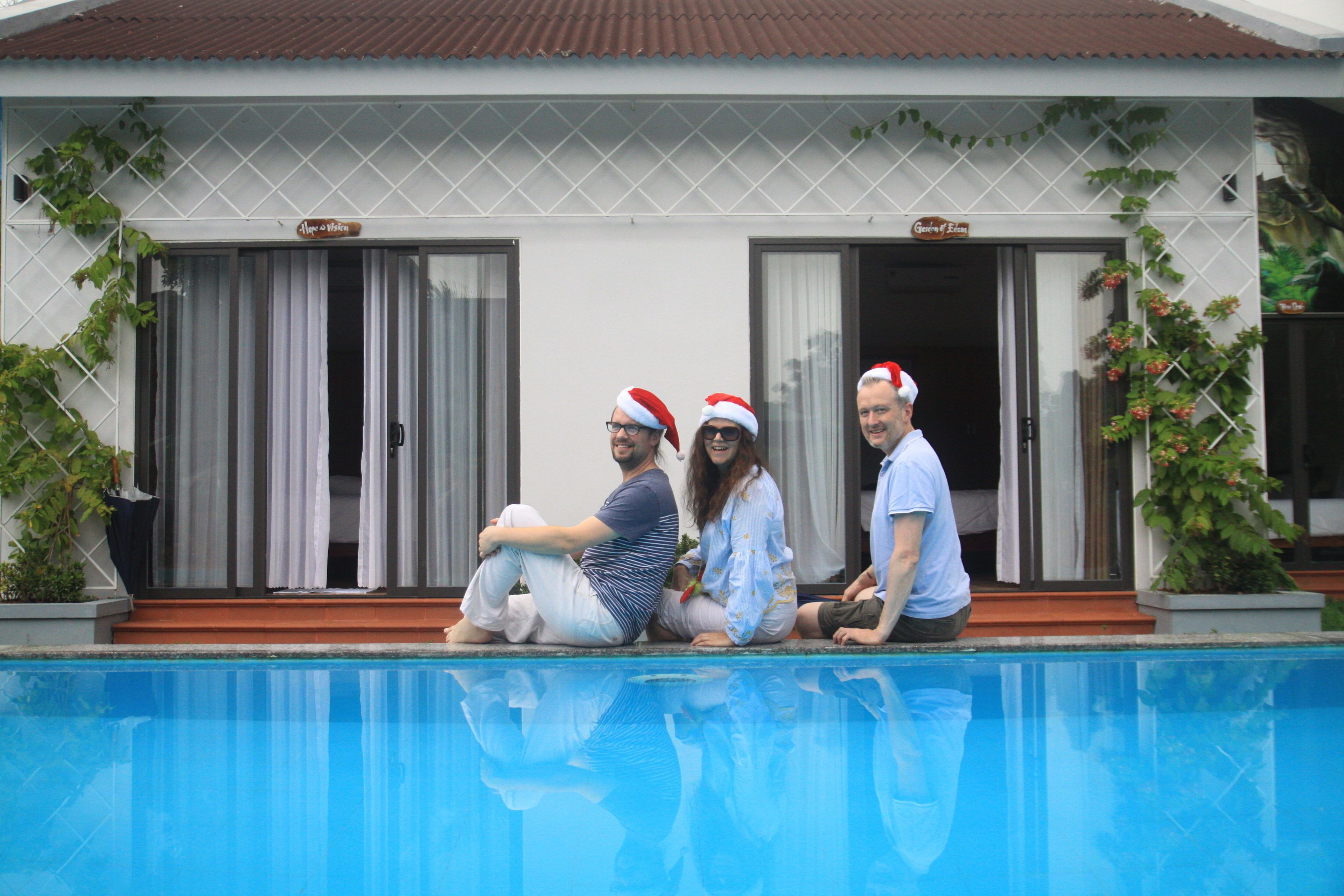 A swimming pool with a house in the background.