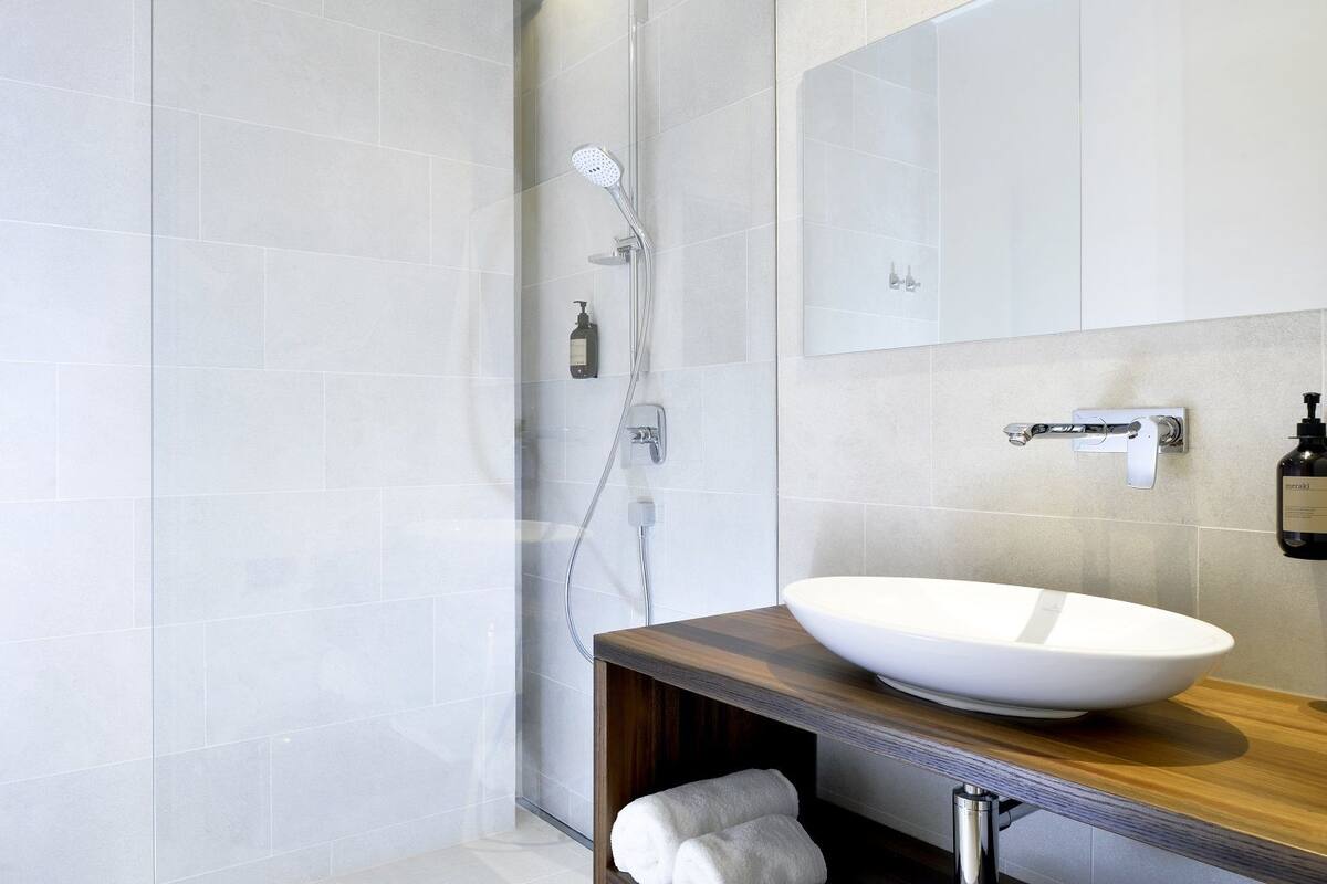 shower, rainfall showerhead, hair dryer, towels