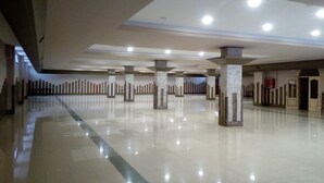 A spacious, well-lit lobby with a polished floor, multiple columns, and a high ceiling. - Hotel Restaurante Dama de Baza (Baza)