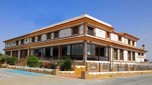 A two-story building with a balcony, large windows, and a pool area. - Hotel Restaurante Dama de Baza (Baza)