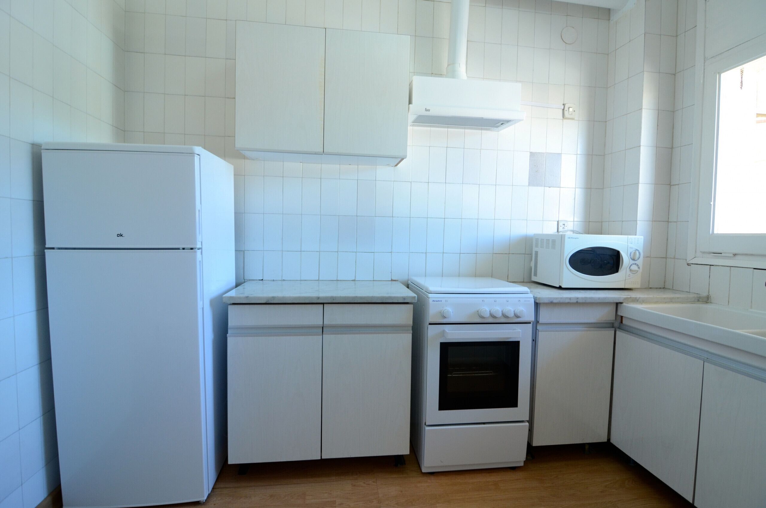 Fridge, microwave, coffee/tea maker, cookware/dishes/utensils