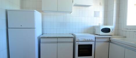 Fridge, microwave, coffee/tea maker, cookware/dishes/utensils
