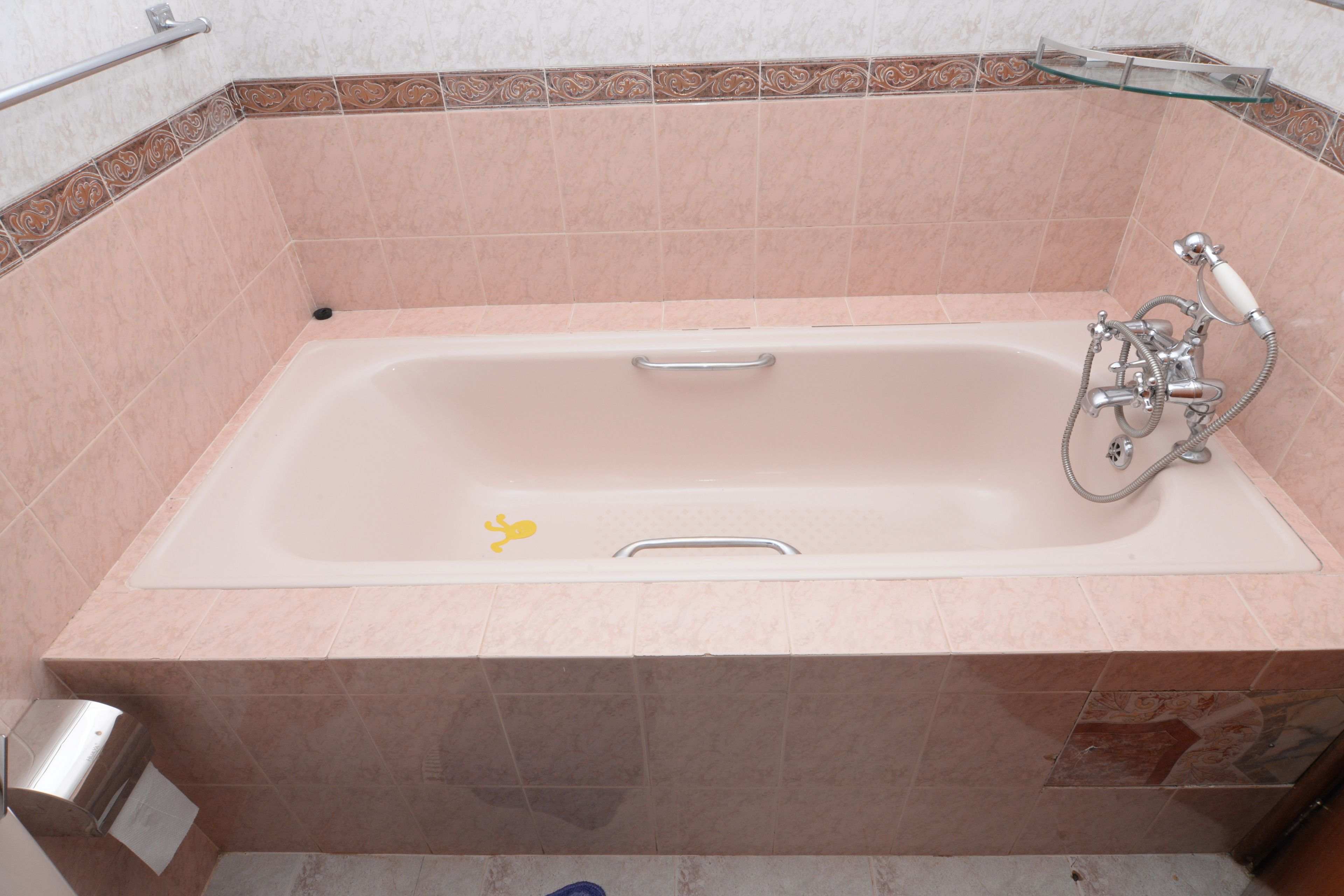 A standard hotel bathroom with a bathtub, a shower, and a toilet.
