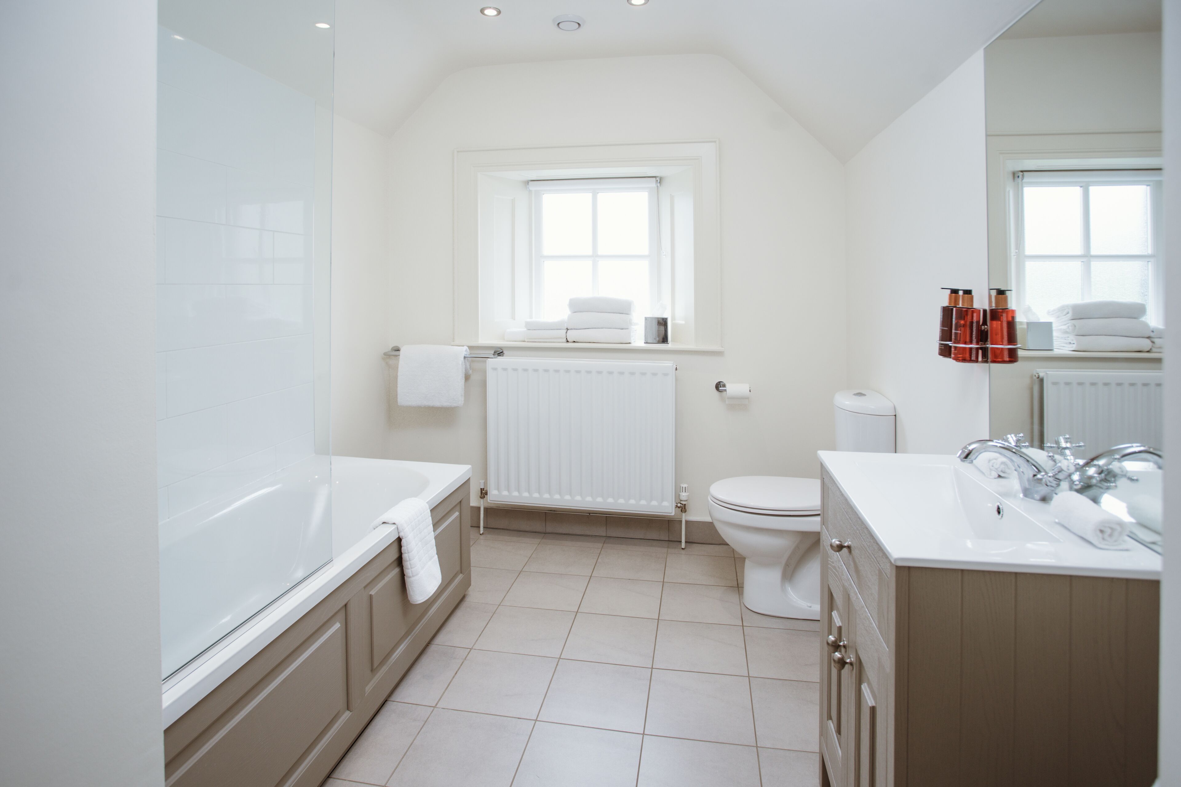 A modern bathroom with a bathtub, toilet, and sink.